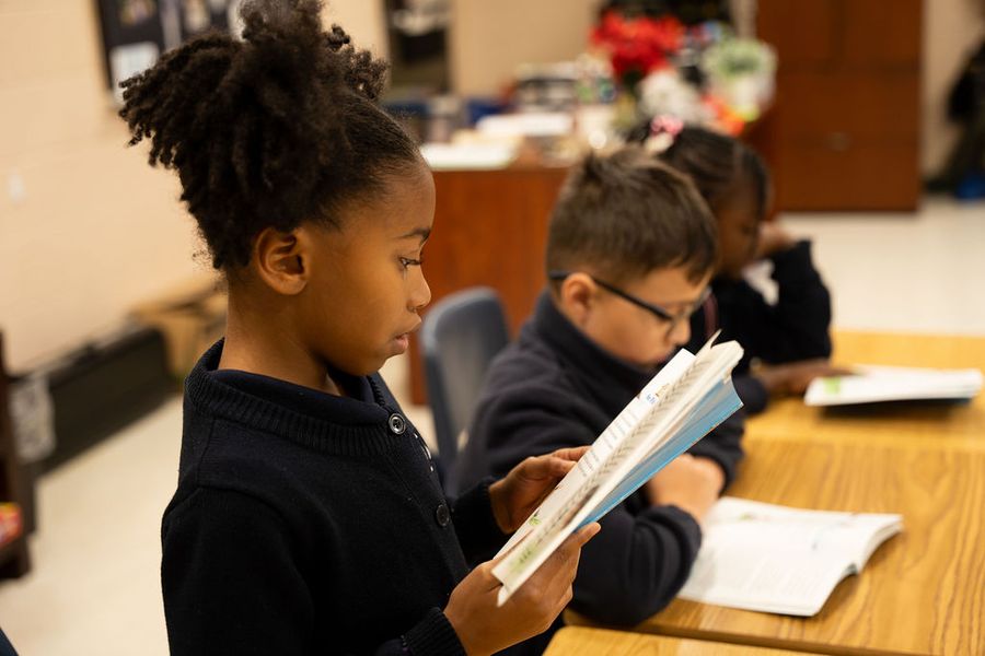 Elementary students reading at their desks