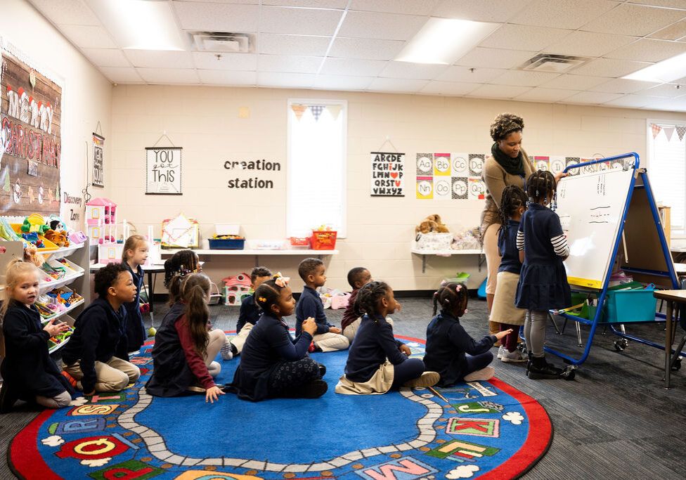 Preschoolers sitting on a rug for circle time